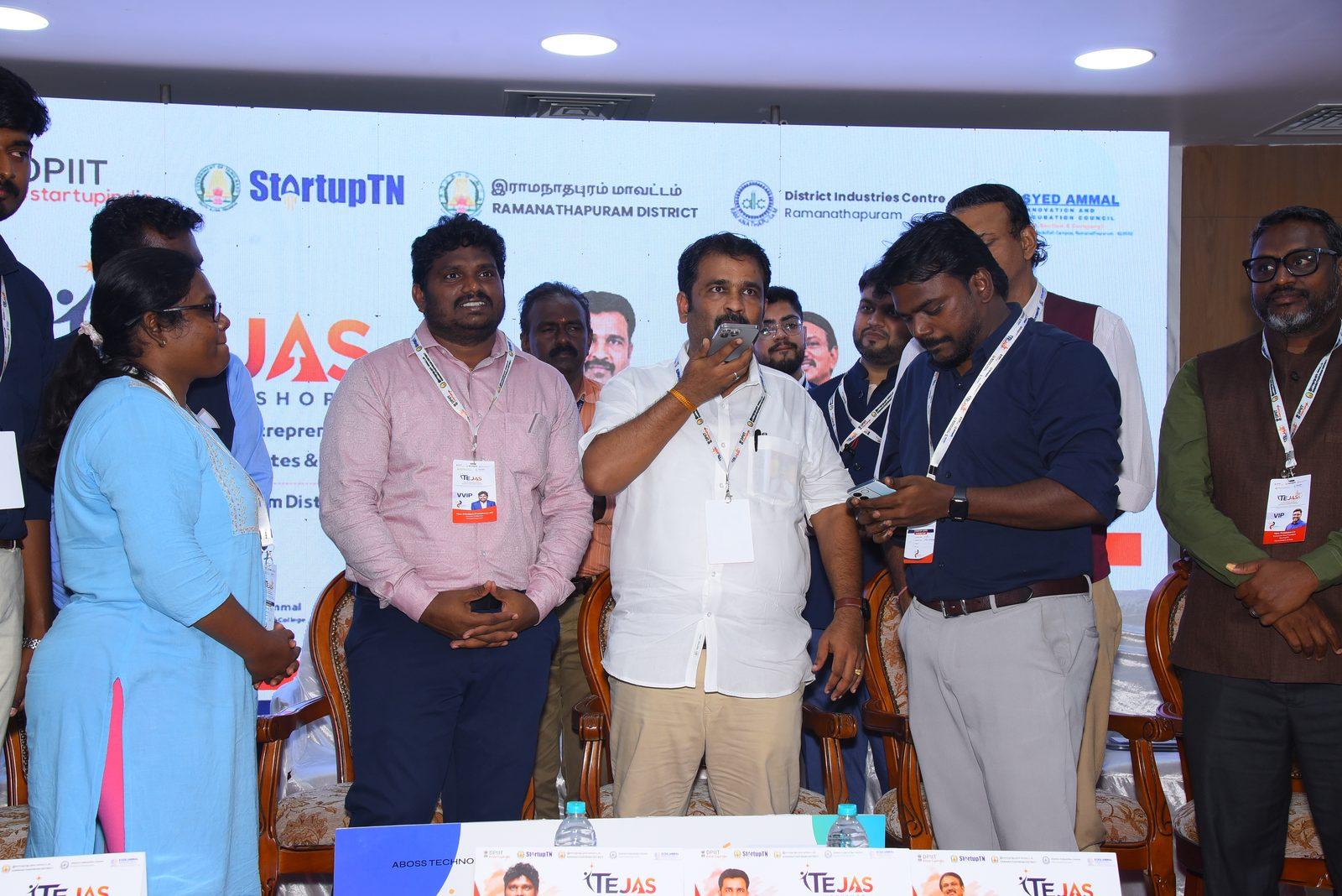 Thiru P. Mathan Raja, Minister of MSME, Government of Tamil Nadu, speaking into a smartphone used as an Alpha Voice microphone on stage at the TEJAS Mega Startup Fest in Ramanathapuram